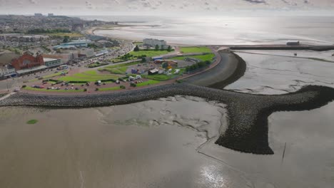 morecambe headland, sea defences, stone groynes and pier. proposed site of eden project. summer. marine road central, morecambe, lancashire, uk