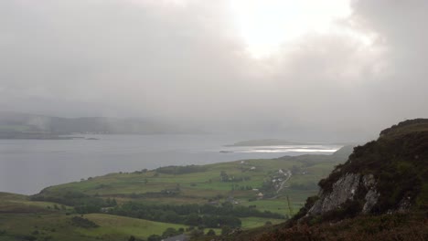 misty and cloud rolling over a rural community on a scottish island