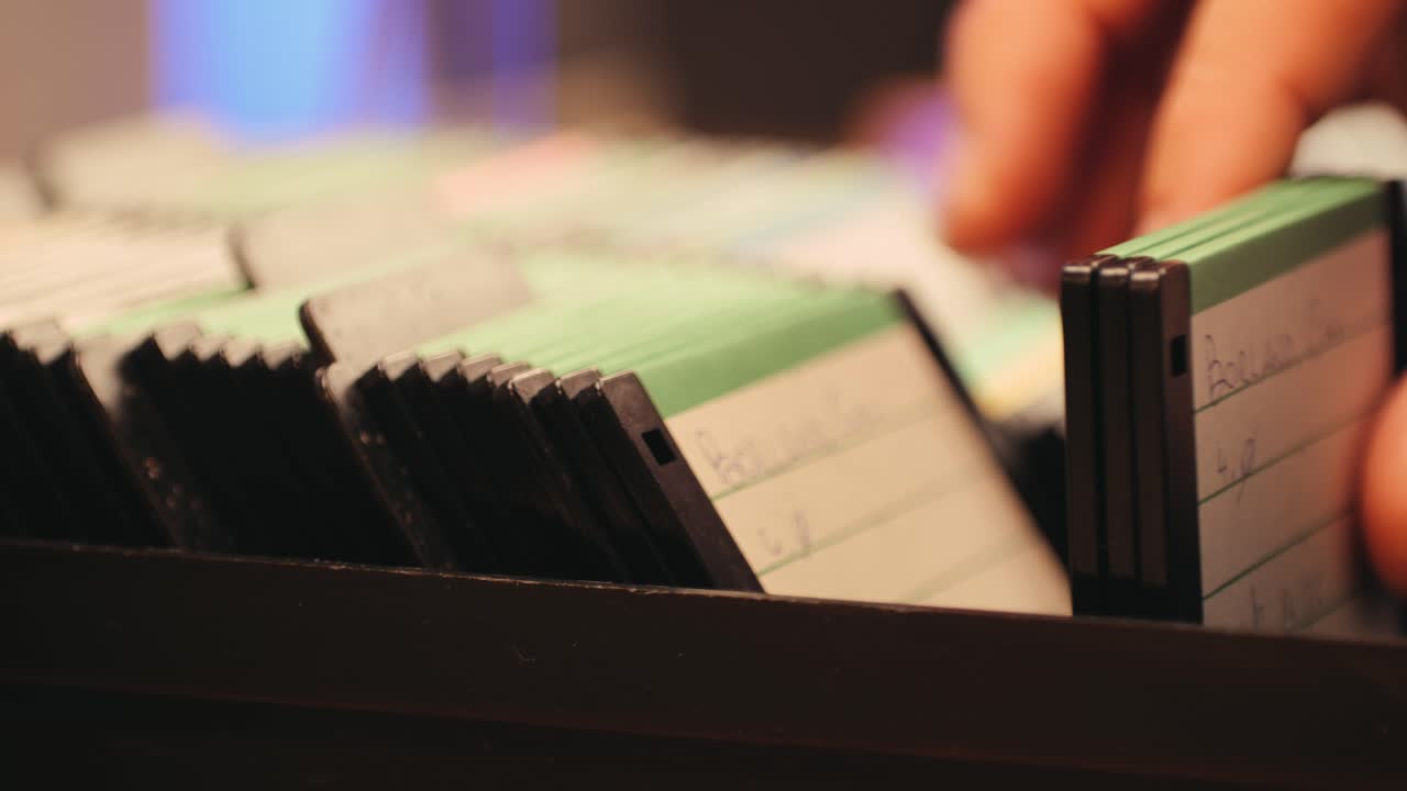 Using diskette for old computer. Music recorder, playing retro computer games. Vintage device for office, obsolete technology. . High quality 4k footage