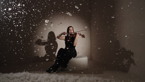 woman playing violin in a winter wonderland studio setting