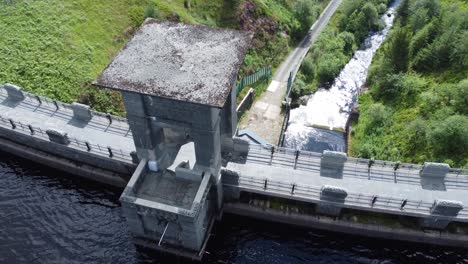 Alwen-reservoir-Welsh-woodland-lake-water-supply-aerial-view-concrete-dam-countryside-park-birdseye-orbit-right