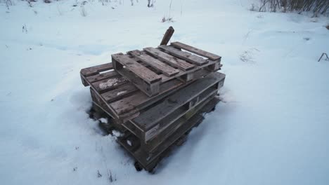 pile of old wooden pallets left on a field