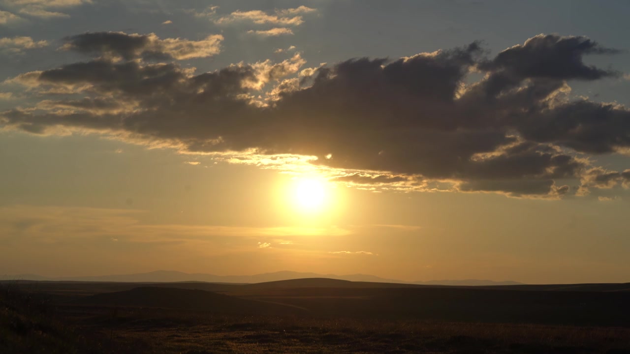 Golden Sunset Over Rolling Hills and Open Landscape