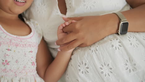 mother and daughter holding hands