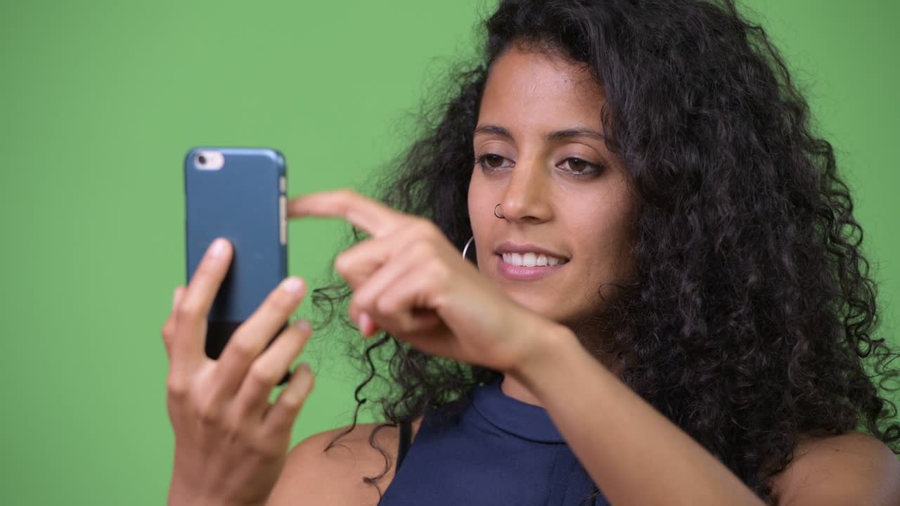 Young beautiful Hispanic businesswoman using phone