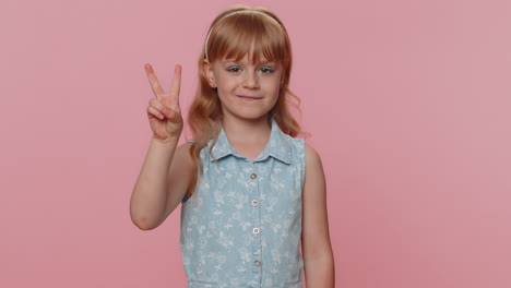 Happy-preteen-child-girl-kid-showing-victory-sign,-hoping-for-success-and-win,-doing-peace-gesture