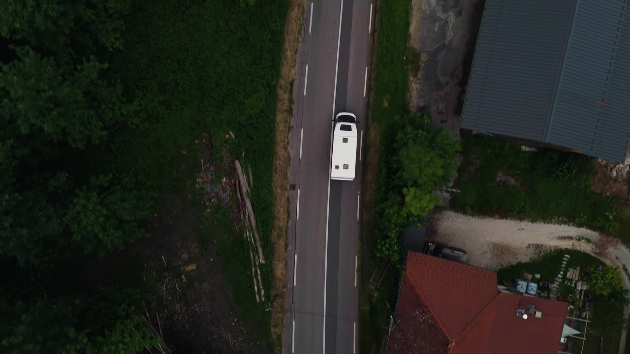 Top down drone shot above a RV driving in a French village, summer in France