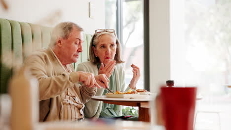 elderly couple enjoying a meal at a cafe