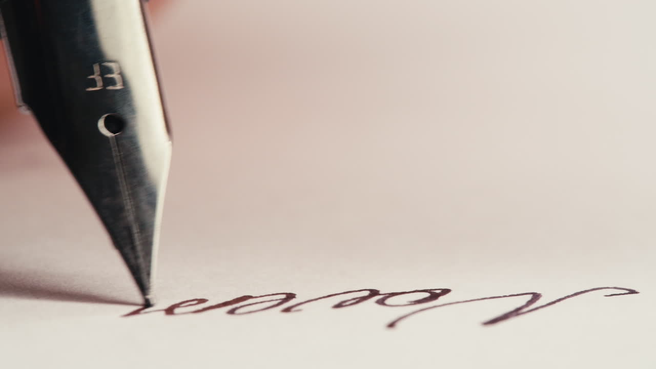 Fountain Pen Writing 'Hello November' on White Paper