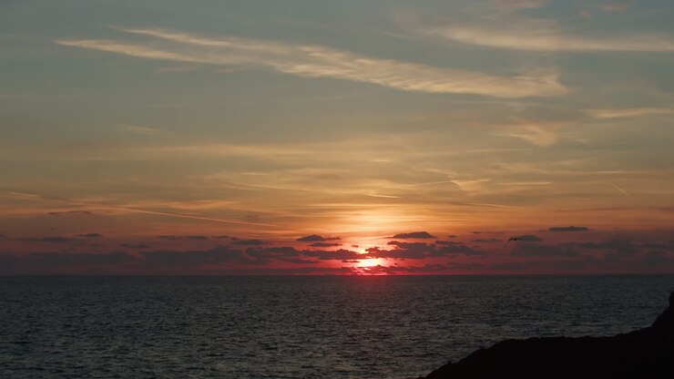 Glowing Ocean Sunset With Silhouette of Flying Seagull Bird Slowly Comes into View - Slow Motion