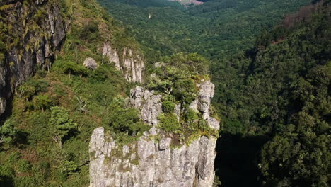 Aerial-drone-shot-of-a-steep-mountain-pillar-formation-in-Drakensberg,-South-Africa