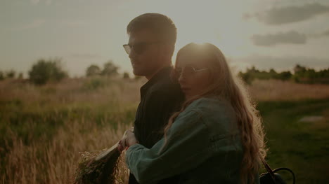 Positive-Woman-Supporting-Young-Man-Outdoors-At-Sunset-2