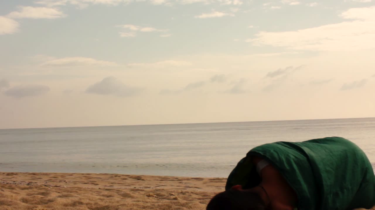 Girl sleeping on the beach in her sleeping bag