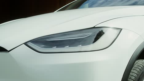 close-up of a white tesla suv headlights