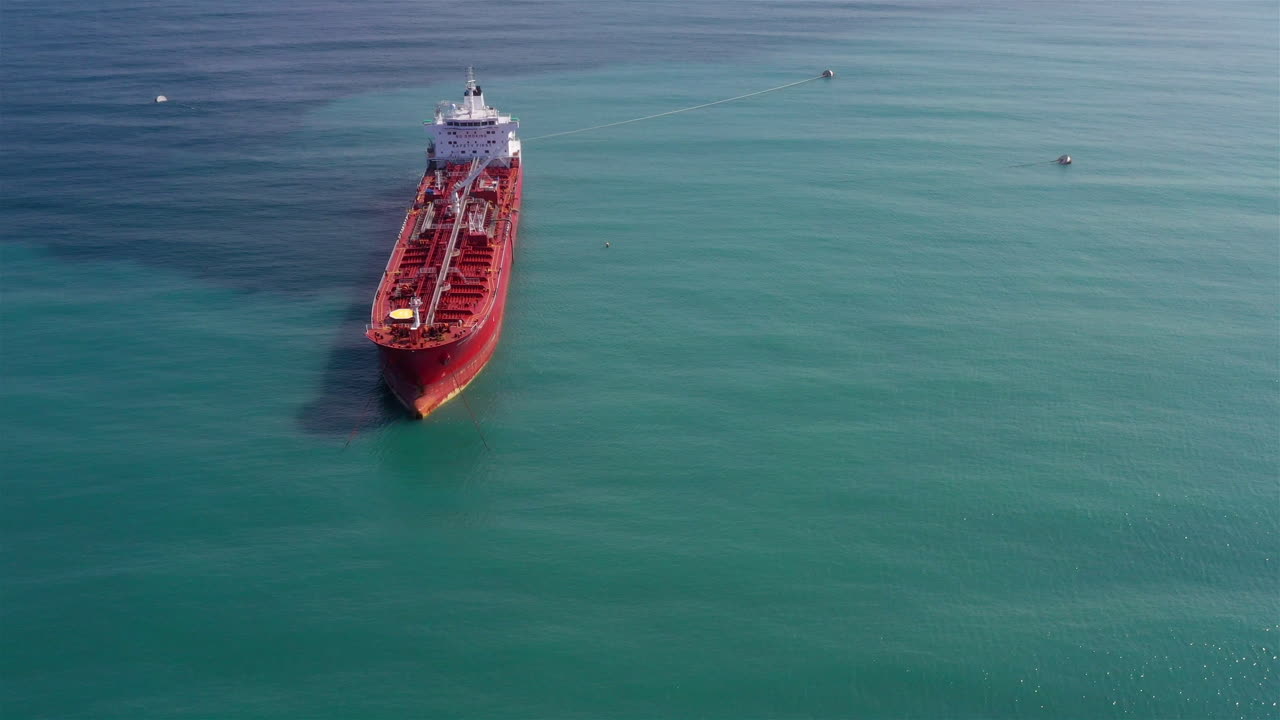 Oil Tanker Tied with strings Close to port Aerial Dolly view