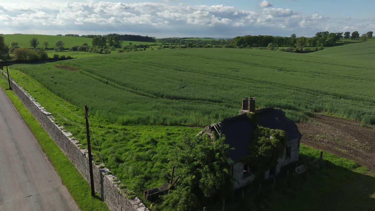 Caledon Border Wall, County Tyrone, Northern Ireland, May 2023. Drone pulls back then slowly descends, lush green fields, historic stone walls and rural charm.