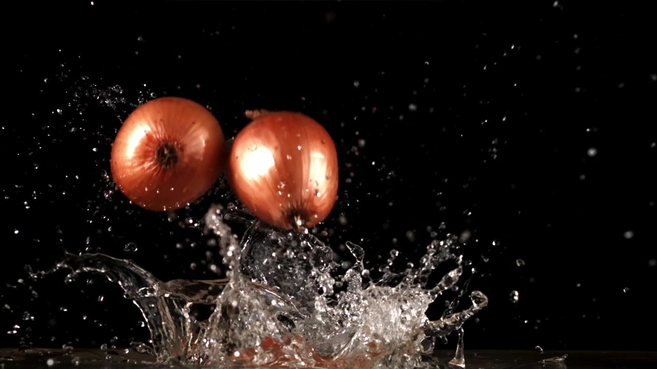 Shallots Splashing into Water in Slow Motion