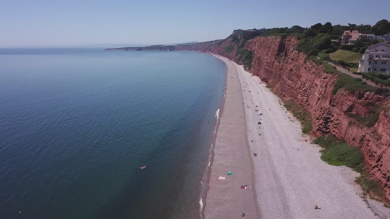 Aerial view of a beach with red cliffs