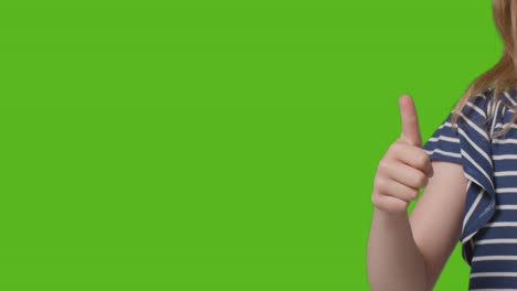 Close-Up-Of-Young-Girl-Giving-Thumbs-Up-Gesture-To-Camera-Against-Green-Screen