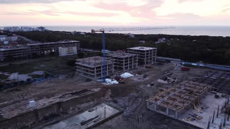 aerial panorama view of construction site, cranes, metal work, building hotels and apartments, future development.