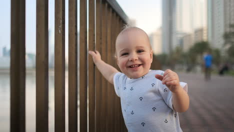 laughing boy at the age of 1 year dancing.
