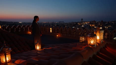 woman on rooftop at night with lanterns