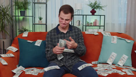 successful happy rich business man counting money cheering up with high profits, lottery game win