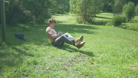 Young-man-doing-Weighted-Russian-Twist-exercise-using-a-kettlebell