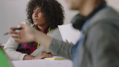 young african american woman student studying working on project writing notes brainstorming ideas in multi ethnic office