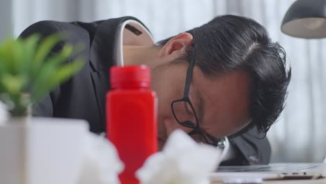 tired businessman sleeping at his desk