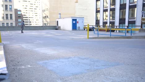 riding an electric board on the top level of a parkade