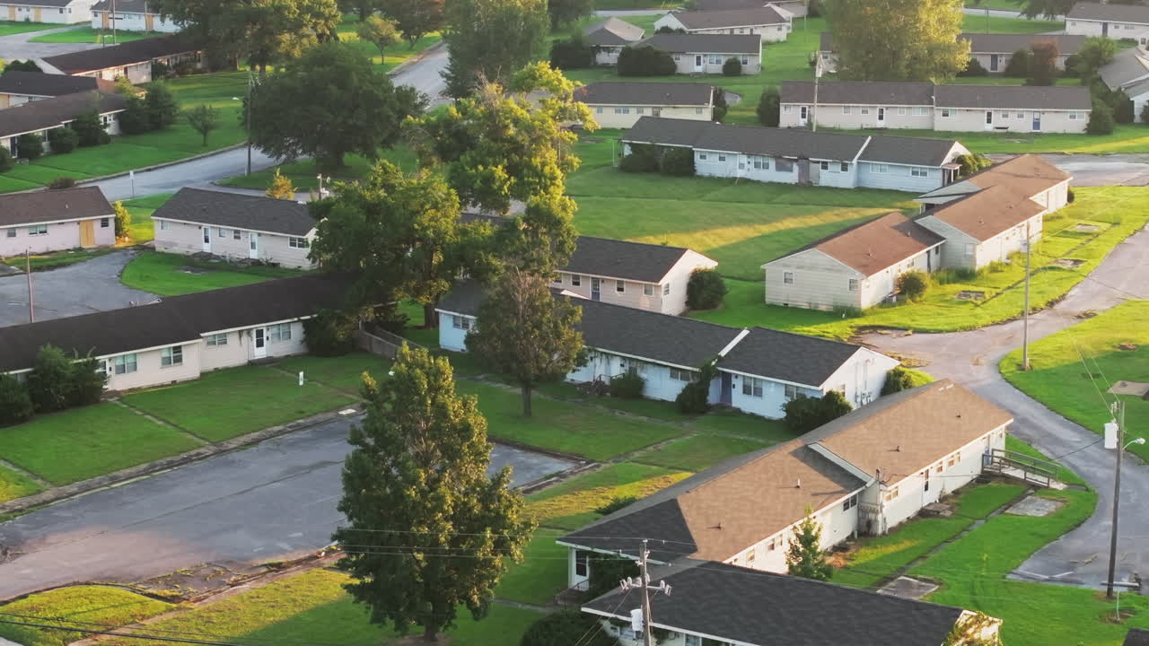 Cinematic drone shot of abandoned apartments with vegetation growing on the buildings, flying over aerial footage
