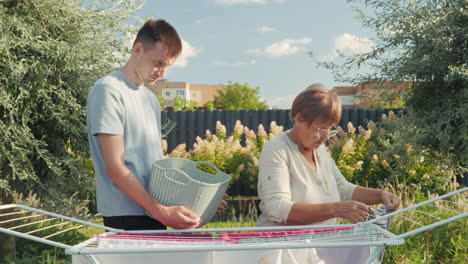 family doing laundry together outside