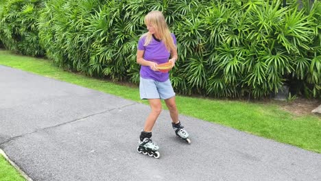 woman rollerblading with watermelon slices in a park