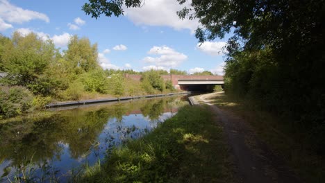 wide shot of the trent and mersey canal going under the a 50 due carriageway