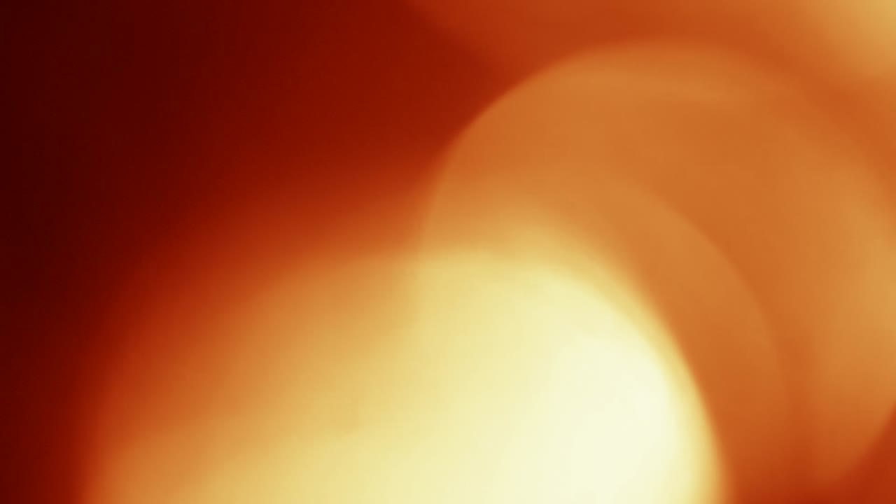 Abstrakter warmer orange-gelber Lichtlecks-Hintergrund