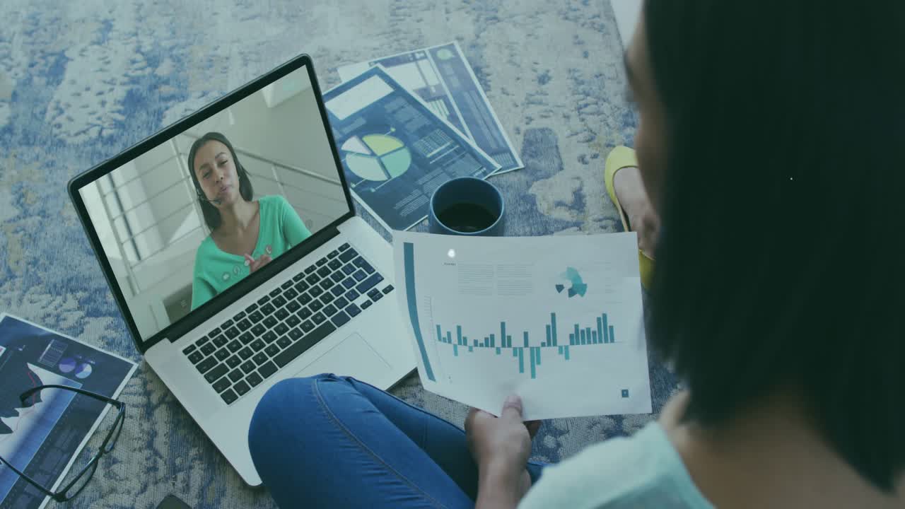 Woman sitting holding chart watching laptop remote peer speaking overlay linking docs for business