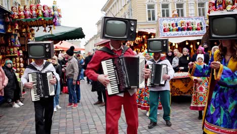 accordion players with tv heads in a winter market