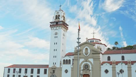 candelaria township church and white tower against blue sky, panning view