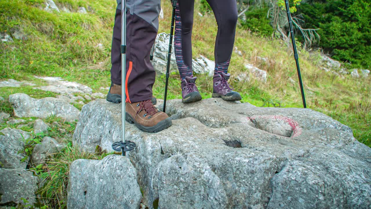 Legs Of Man and Woman Wearing Activewear Hiking Pants and Leggings While Trekking