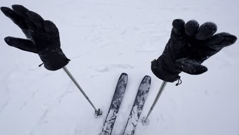 slow rotation around a pair of ski poles winter gloves and skis in a blizzard snow condition in british columbia, canada