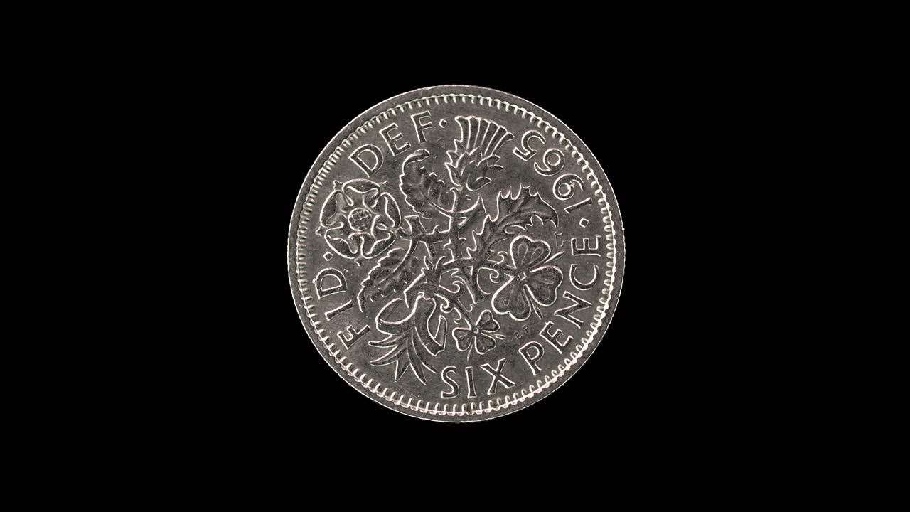 United Kingdom 1965 sixpence coin reverse with floral emblems of the four nations rotating on black background