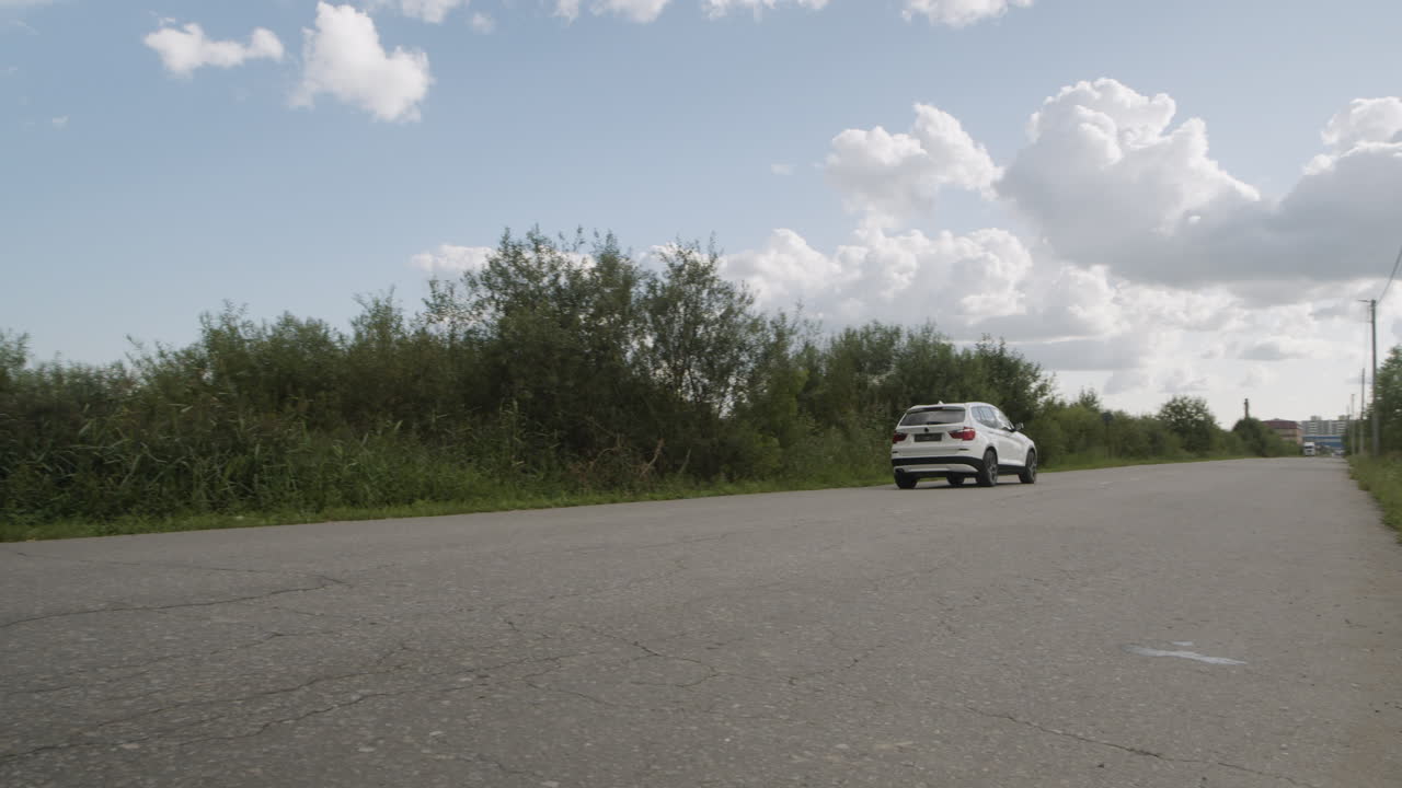 White SUV Driving on a Rural Road