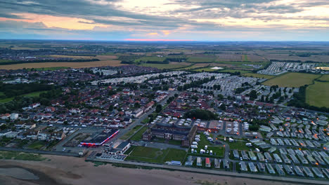 Experience-Skegness-summer-sunset-through-drone-video:-holiday-park,-caravans,-sea,-and-beach-in-mesmerizing-views