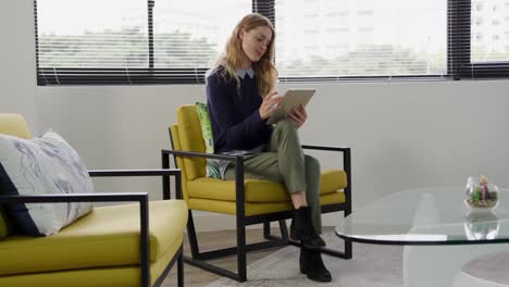 woman sitting and looking at touch pad