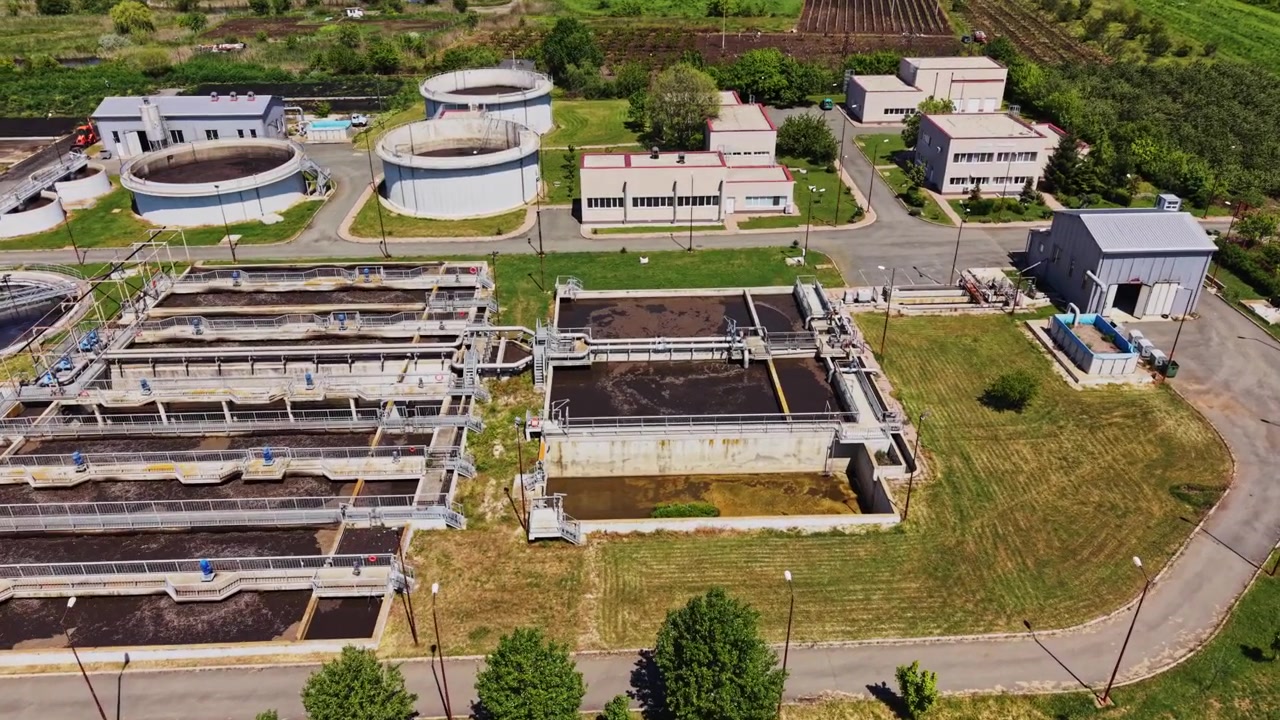 Water treatment facility in a rural area with tanks and buildings