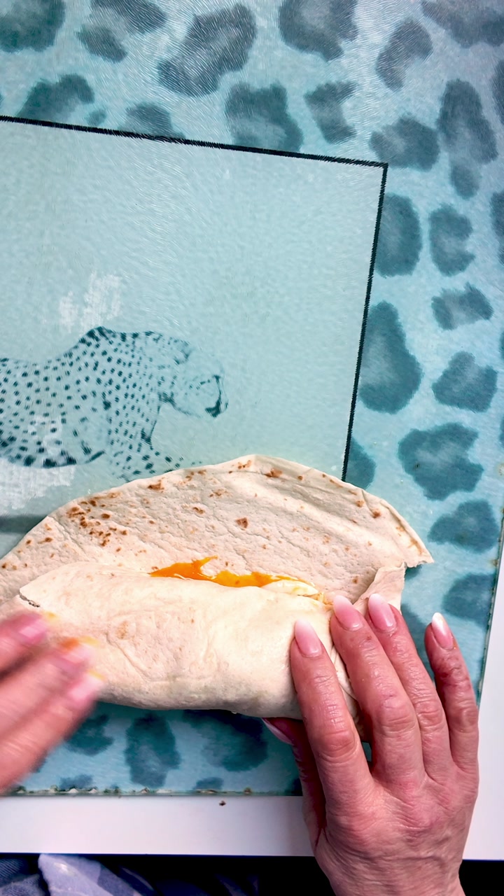 Folding Tortilla wrap stuffed with tasty appetising food ingredients