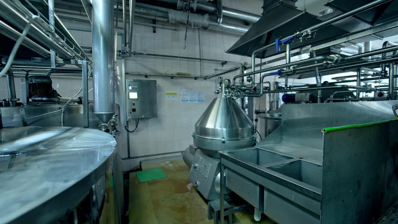 Dairy factory. Metal equipment with industrial pipes for milk processing indoors. Automated technology on a milk farm.