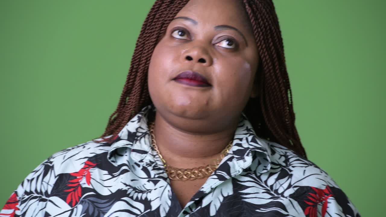 초록색 배경에 비해 과체중이 많은 아름다운 아프리카 여성