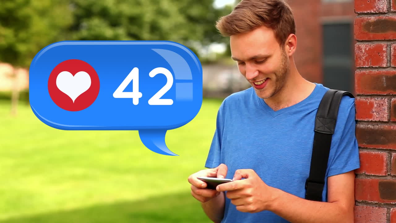 Man leaning on a brick wall checking his phone